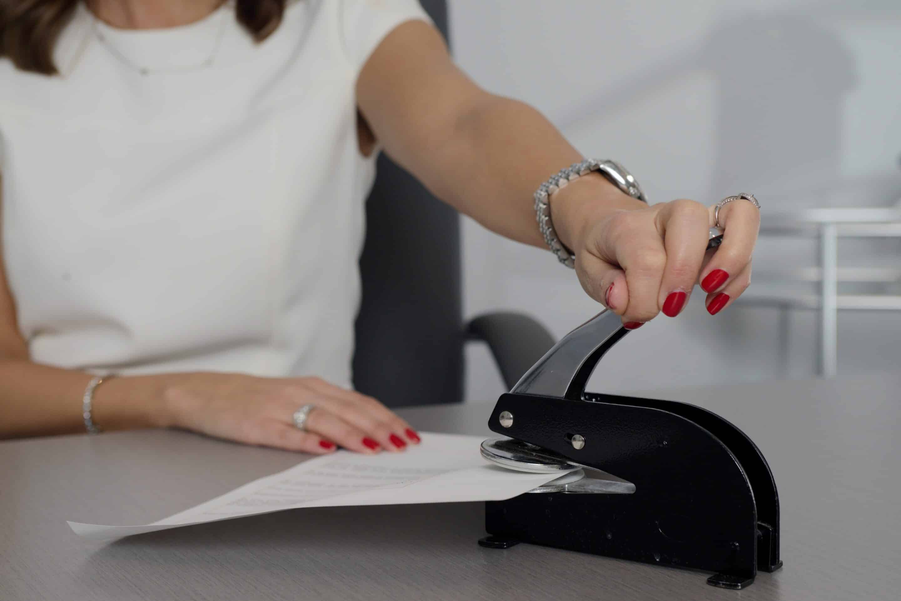 Woman stapling papers